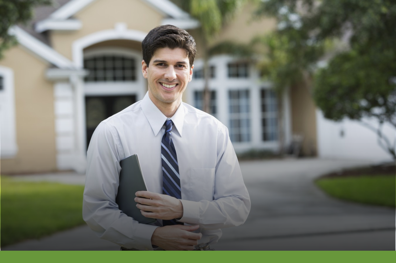 Real Estate Commission Smiling formally dressed man holding a folder while standing in front of a house