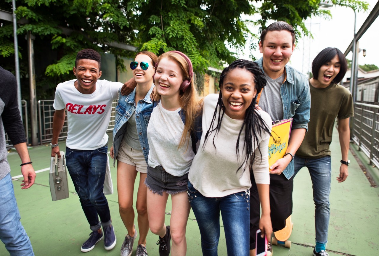 YTAC Image shows diverse group of teens, smiling and looking at the camera