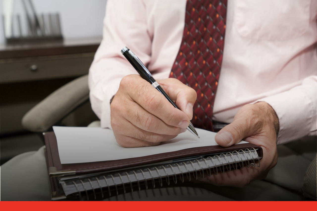 Private Probation Service Hands of a formally dressed man writing on a notepad