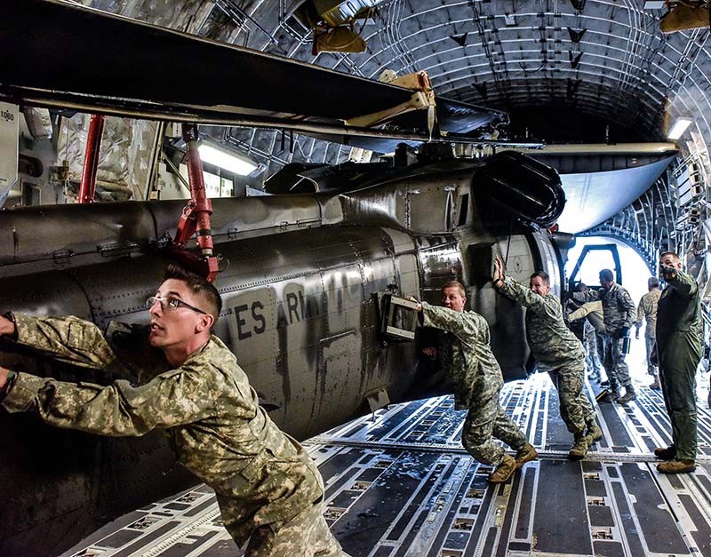 PHOTO CAPTION 1 & 2:  Tennessee National Guard Soldiers push a UH-60 Blackhawk into a C-17 aircraft carrier Sept. 13 at Joint Base Berry Field, Nashville, Tennessee. The Tennessee National Guard deployed to the U.S. Virgin Islands to support disinter relief efforts and provide humanitarian aid in the aftermath of Hurricane Irma. (Photo by Spc. Lauren Ogburn, Tennessee National Guard Public Affairs Office).