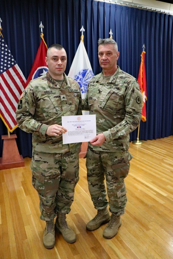 Photo of Maj. Gen. Jeff Holmes, Tennessee’s Adjutant General, presents Sgt. Ryan Grillo