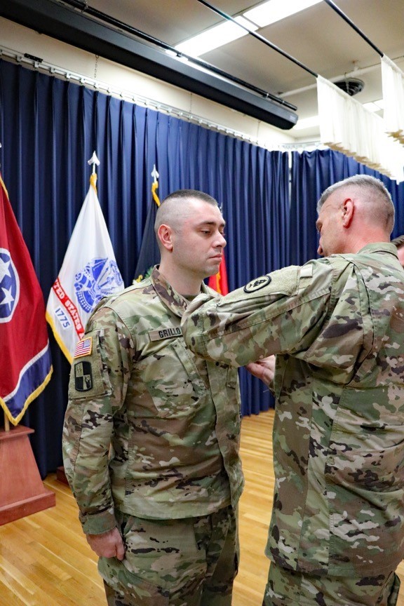 Maj. Gen. Jeff Holmes, Tennessee’s Adjutant General, presents Sgt. Ryan Grillo, a Soldier with the 1176th Transportation Company, the Adjutant General’s Ribbon for Valor