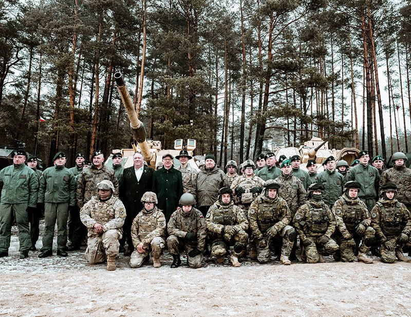 U.S. Secretary of State Michael R. Pompeo poses with Allied troops from NATO’s Enhanced Forward Presence Forces, which include soldiers of the 278th Armored Cavalry Regiment, at the Bemowo Piskie Training Area in Poland on February 13, 2019. 