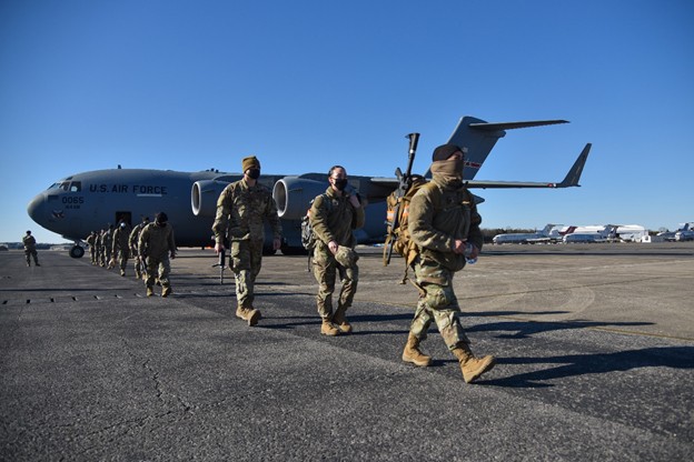 Tennessee National Guard Soldiers on runway with plane in background