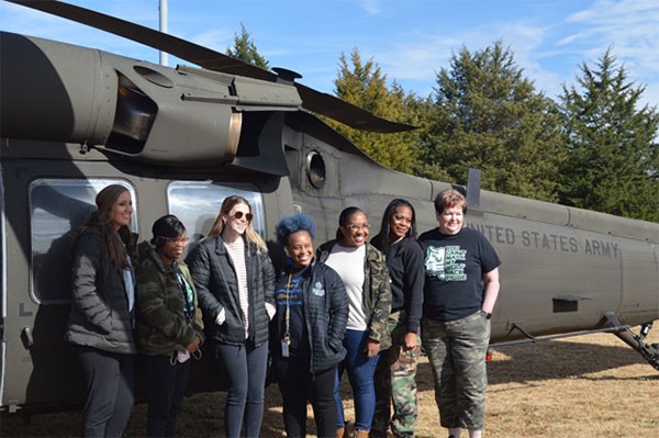 Teachers from Cordova High School pose alongside a UH-60 Blackhawk helicopter in Cordova on Nov. 18. Several of the school’s teachers and staff flew aboard two Blackhawks as part of an educators’ flight organized by recruiters from the Tennessee National Guard. (Photo by Sgt. Finis L. Dailey, III)
