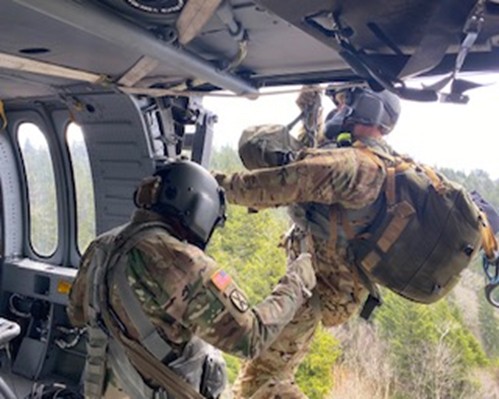 Guard members using hoist on helicopter