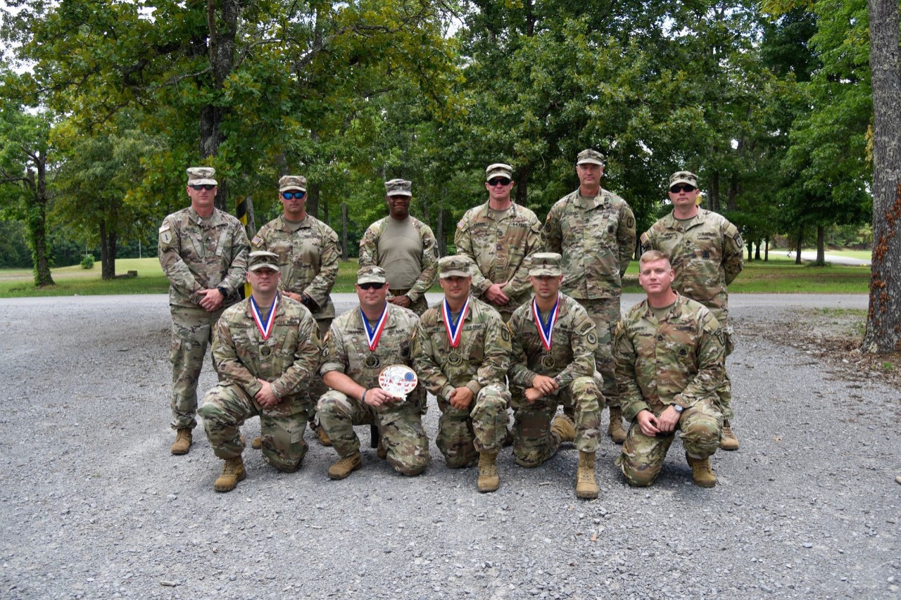 Staff Sgt. Sean Hart (center, front) poses with members of the 117th Regimental Training Institute, June 27, after competing in the Tennessee National Guard’s annual TAG Match. The TAG Match is an annual marksmanship competition and training event that is hosted by the Tennessee Combat Marksmanship Program. (Photo by Sgt. 1st Class Timothy Cordeiro)