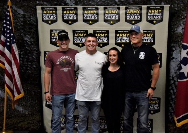 Pfc. Brandon Morehead poses with his brother, mother, and father after he swears in to the Tennessee Army National Guard at the Smyrna Bowling Center on July 23. (Photo by Sgt. James Bolen)