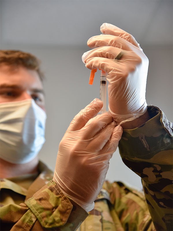 Spc. Anthony Spencer with the Tennessee National Guard prepares a vaccination dose for a patient at the Trousdale County Health Department on June 9. (Photo by Lt. Col. Darrin Haas)