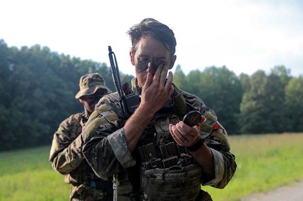 Staff Sgt. Colin Wheeler applies tactical camouflage prior to the squad’s field training exercise during the two-week patrol course, Aug. 6-20, held in Lavinia. (Photos by Capt. Kealy Moriarty)