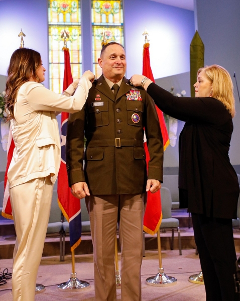 Col. Michael “Trent” Scates is promoted to the rank of brigadier general by his wife, Beth, and his daughter, McCall, during a ceremony held at the First Baptist Church in Greenfield, March 26. (photo by Staff Sgt. Mathieu Perry)