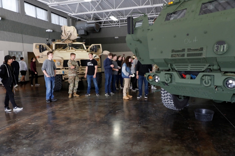 Students from Coffee County Central and Tullahoma High Schools tour a HIMARS, or High Mobility Artillery Rocket System, and an M-ATV, or Mine-resistant ambush protected All-Terrain Vehicle, during a career day at the Tullahoma National Guard Armory on April 6. (photo by Lt. Col. Marty Malone)
