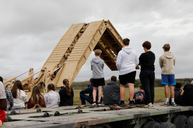 Students from Coffee County Central and Tullahoma High Schools watch a demonstration of the M-60 Armored Vehicle Launched Bridge being deployed during a career day at the Tullahoma National Guard Armory on April 6. (photo by Lt. Col. Marty Malone)