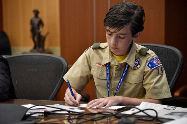 A scout writes a letter to an elected official while earning the citizenship in the nation merit badge at the 2nd Annual Merit Badge University hosted by the Tennessee Military Department at the Joint Force Headquarters in Nashville, April 29. (photo by retired Sgt. 1st Class William Jones)