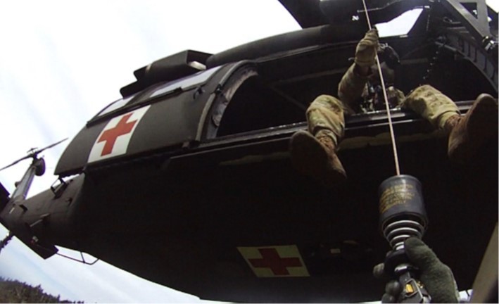 Tennessee Army National Guard Blackhawk helicopter crew chief, Sgt. Daniel Bandy, hoists flight paramedic, Sgt. 1st Class Giovanni DeZuani, into the aircraft after rescuing a hiker in respiratory distress in the Great Smoky Mountain National Park, at Mount LeConte Lodge, in the late afternoon of May 31.  (submitted photo) 