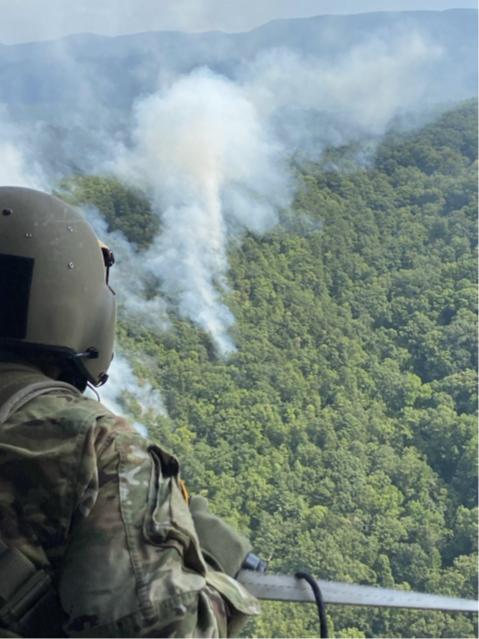 A Tennessee National Guard UH-60 Blackhawk helicopter crewchief, from Knoxville’s 1-230th Assault Helicopter Battalion, monitors the wildfires in the Great Smoky Mountains National Park, August 27. (submitted Tennessee National Guard photo) 