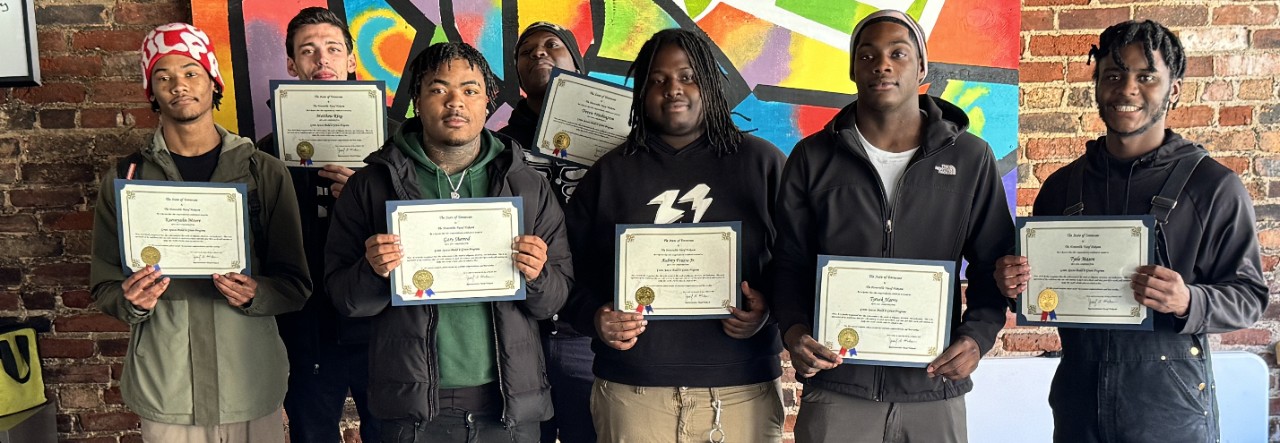 Adult Education A group of students hold certificates